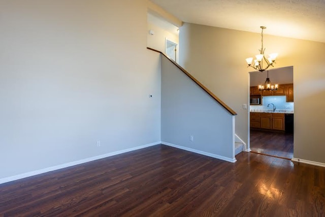 interior space featuring lofted ceiling, dark wood-style floors, stairs, and a notable chandelier