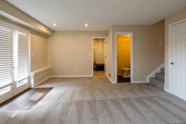 carpeted spare room featuring recessed lighting, stairway, and baseboards