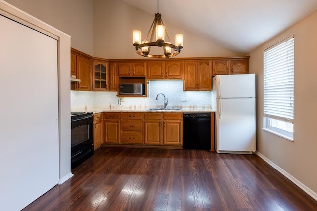 kitchen with lofted ceiling, a notable chandelier, a sink, light countertops, and black appliances