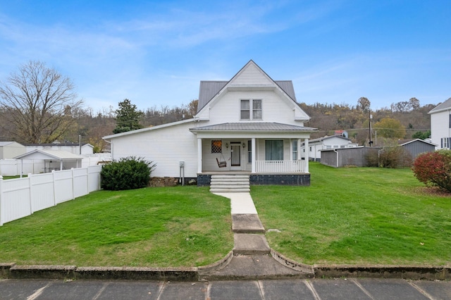 view of front of property featuring covered porch and a front lawn