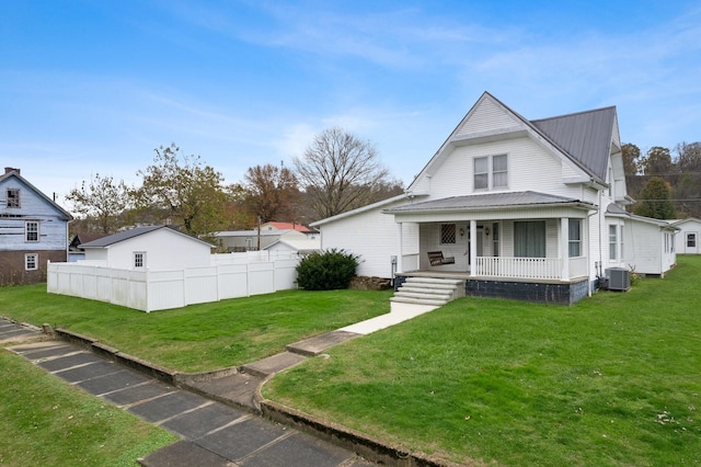 view of front of property featuring a porch, central AC unit, and a front lawn