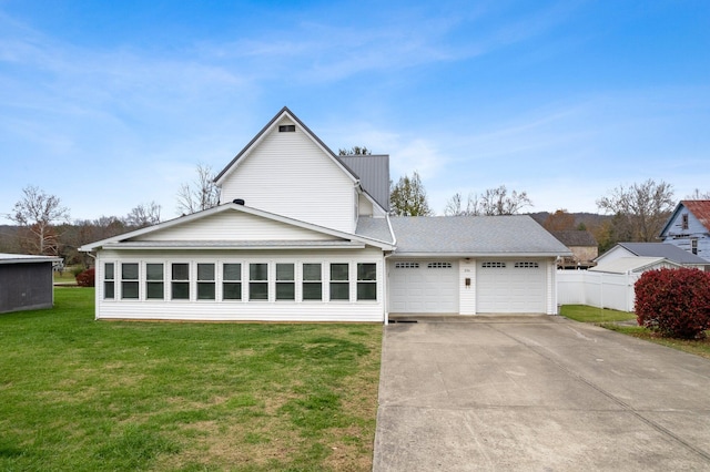 view of front of house with a garage and a front lawn