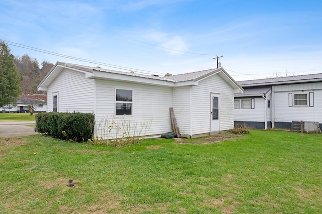 view of side of home with a lawn