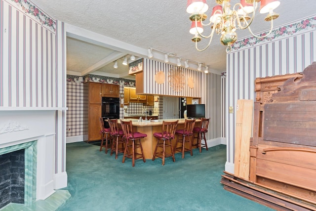 carpeted dining area with beam ceiling, sink, a textured ceiling, and an inviting chandelier