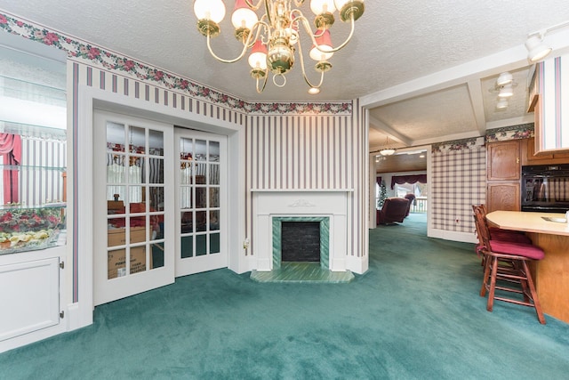 unfurnished living room with dark colored carpet, plenty of natural light, a textured ceiling, and a notable chandelier