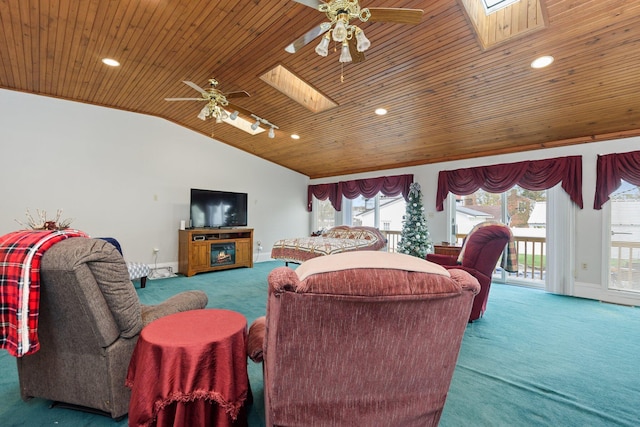 carpeted living room featuring ceiling fan, lofted ceiling with skylight, and wooden ceiling