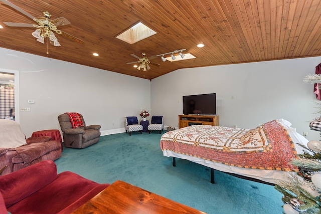 carpeted living room featuring vaulted ceiling with skylight, ceiling fan, and wood ceiling