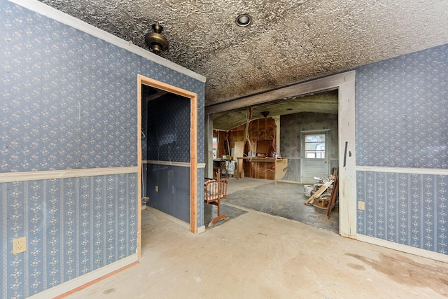 interior space featuring carpet floors, a textured ceiling, and ornamental molding