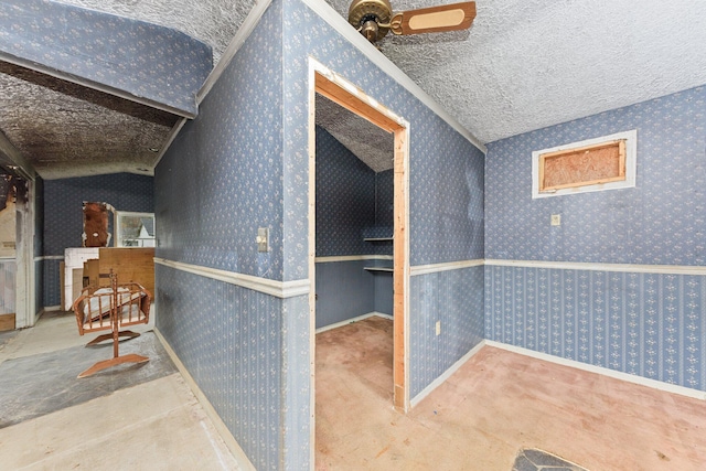 interior space with carpet flooring, vaulted ceiling, and a textured ceiling