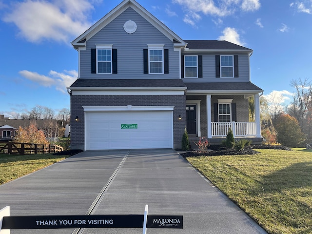 view of front of property featuring a porch, a garage, and a front lawn