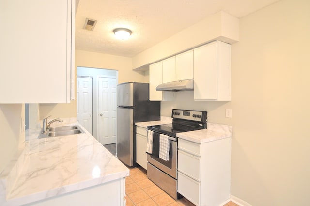 kitchen with a textured ceiling, stainless steel appliances, sink, white cabinetry, and light tile patterned flooring