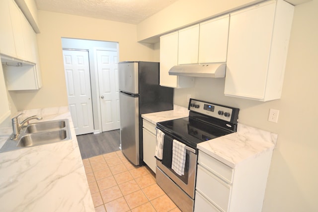 kitchen featuring a textured ceiling, white cabinetry, sink, and appliances with stainless steel finishes