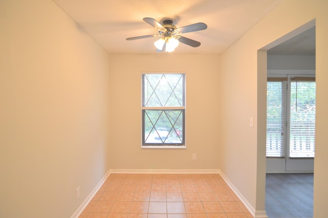 unfurnished room featuring ceiling fan and light tile patterned floors