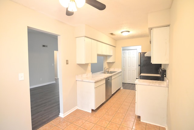 kitchen featuring white cabinets, stove, light wood-type flooring, and sink