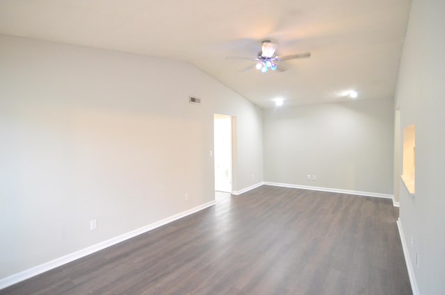 spare room featuring ceiling fan, dark wood-type flooring, and vaulted ceiling