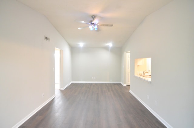 empty room with dark hardwood / wood-style flooring, ceiling fan, and lofted ceiling