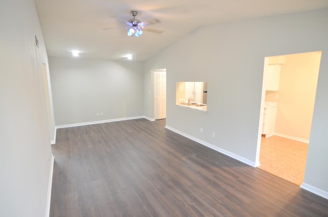 unfurnished room with vaulted ceiling, ceiling fan, and dark hardwood / wood-style floors