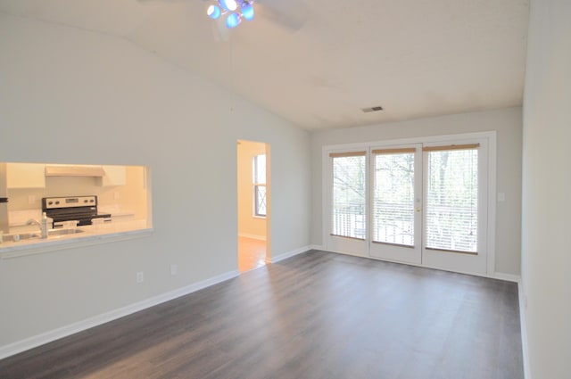 spare room featuring ceiling fan, sink, dark wood-type flooring, and vaulted ceiling