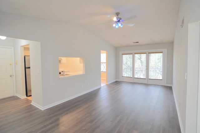 spare room with ceiling fan, dark hardwood / wood-style flooring, and vaulted ceiling