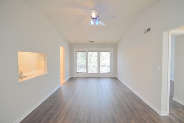 unfurnished room with dark hardwood / wood-style floors, vaulted ceiling, and ceiling fan