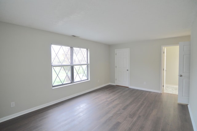 empty room with dark wood-type flooring