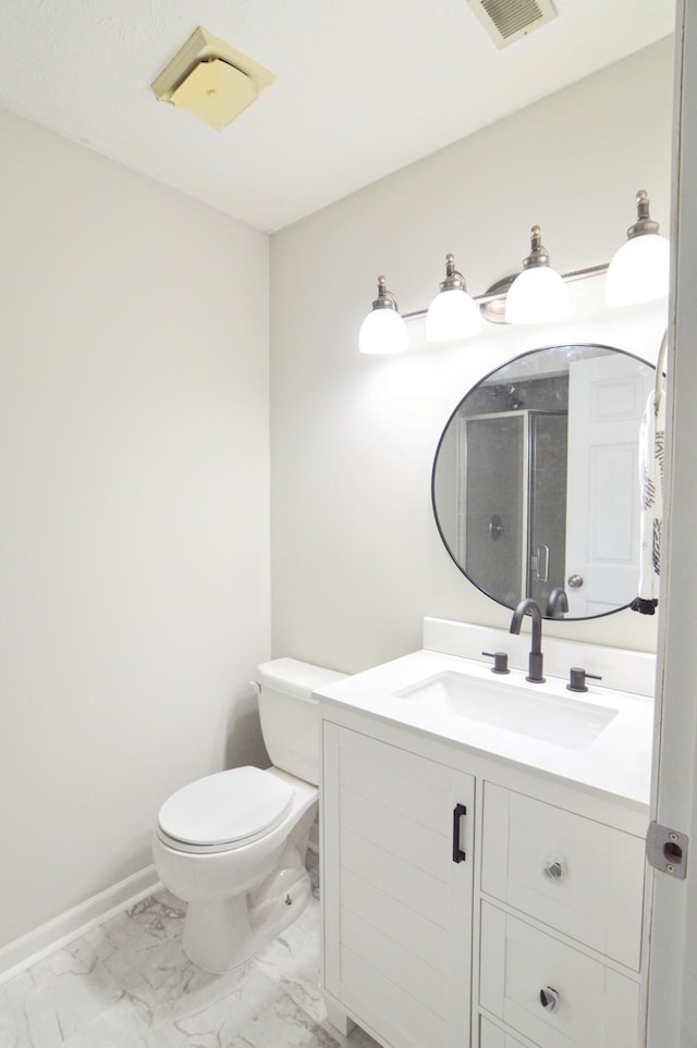 bathroom with vanity, a shower with shower door, and toilet