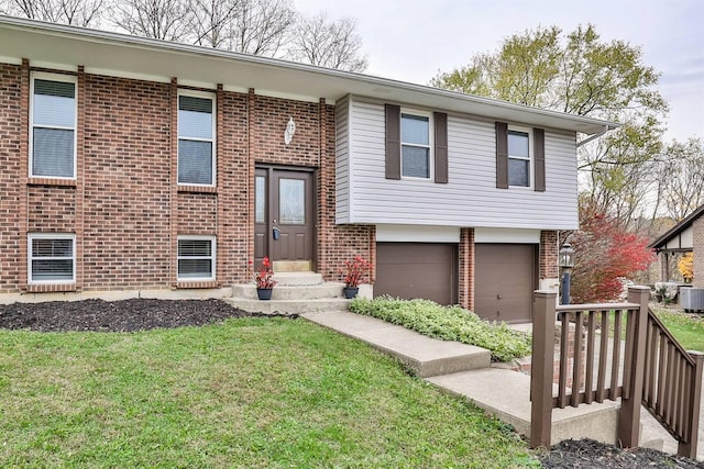 split foyer home with cooling unit, a front lawn, and a garage