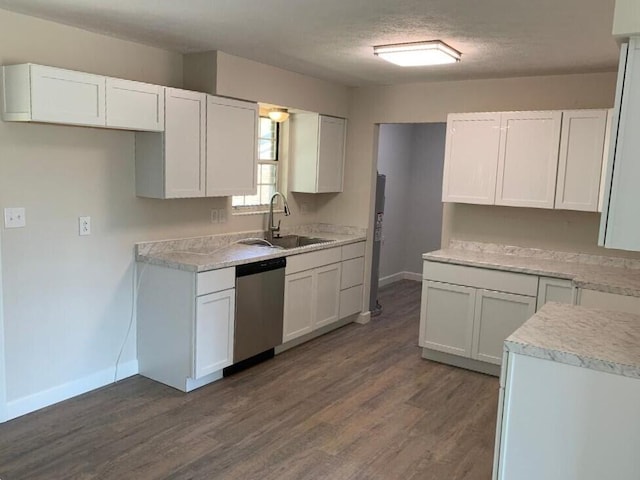 kitchen with dark hardwood / wood-style flooring, sink, white cabinets, and stainless steel dishwasher