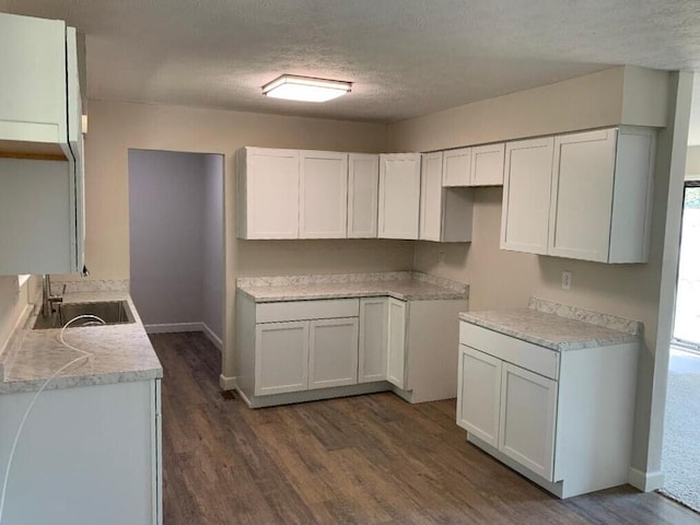 kitchen with a wealth of natural light, white cabinetry, and dark wood-type flooring