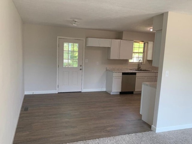 kitchen with dark wood-type flooring, white cabinets, sink, stainless steel dishwasher, and a textured ceiling