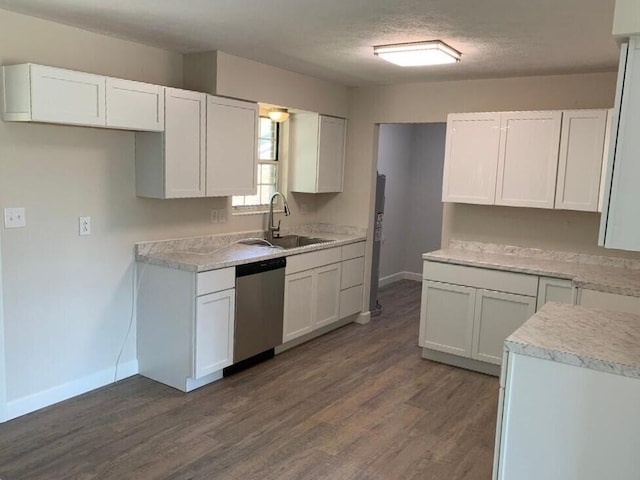 kitchen featuring dark wood-type flooring, white cabinetry, sink, and stainless steel dishwasher