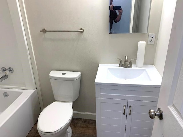 full bathroom with hardwood / wood-style flooring, vanity, toilet, and shower / washtub combination