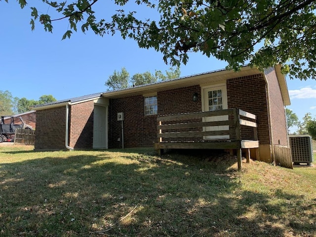 back of house featuring a deck and a yard