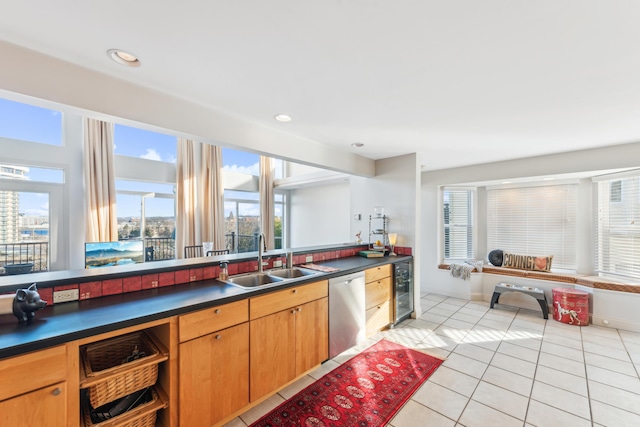 kitchen with sink, light tile patterned floors, stainless steel dishwasher, and beverage cooler