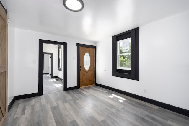 foyer entrance featuring a barn door and light wood-type flooring