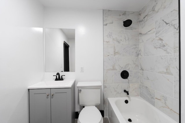 full bathroom with vanity, tiled shower / bath combo, and toilet