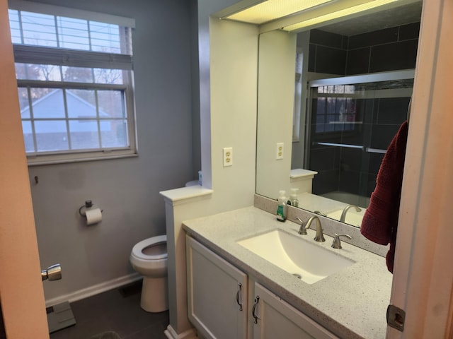 bathroom featuring a shower with shower door, toilet, and vanity