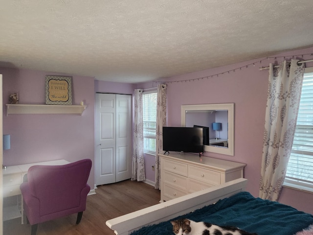 bedroom featuring a textured ceiling, a closet, and hardwood / wood-style flooring