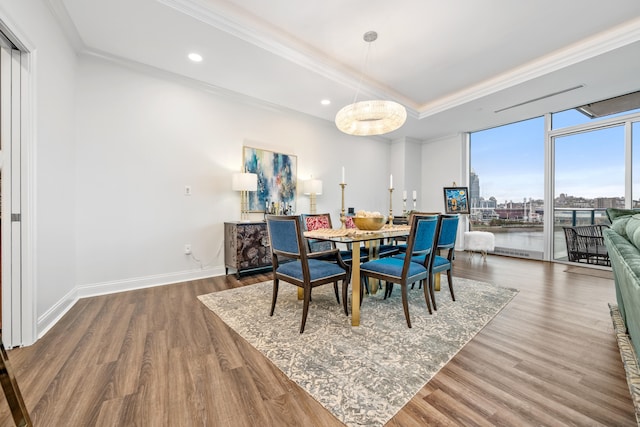 dining area featuring hardwood / wood-style floors and ornamental molding