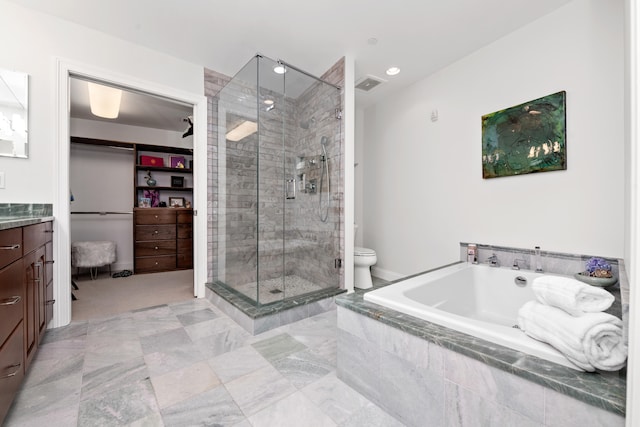 full bathroom featuring toilet, vanity, and shower with separate bathtub