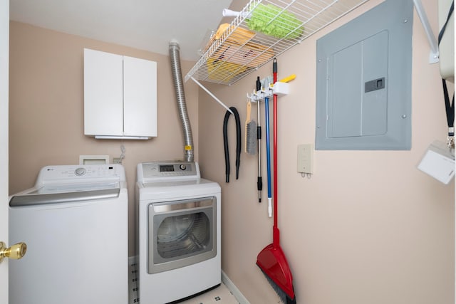 clothes washing area with washer and clothes dryer, cabinets, and electric panel