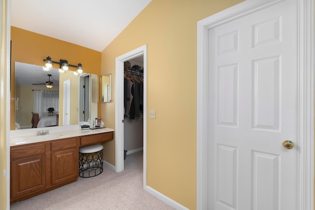 bathroom with vanity, vaulted ceiling, and ceiling fan