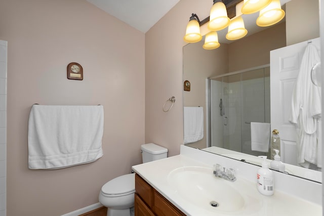 bathroom with lofted ceiling, vanity, an enclosed shower, and toilet