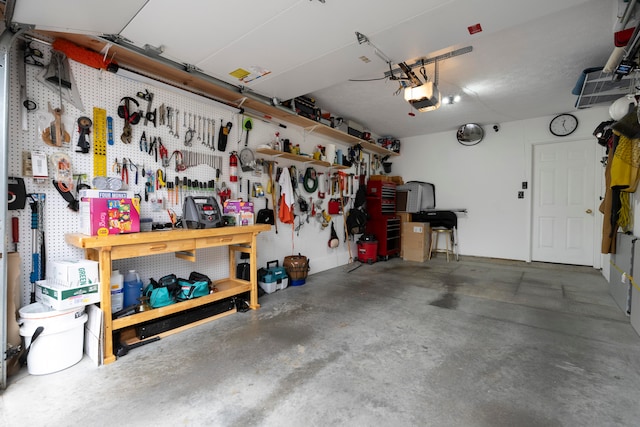 garage featuring a workshop area and a garage door opener