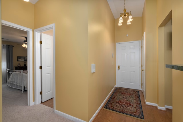 interior space featuring a notable chandelier, a high ceiling, and light hardwood / wood-style flooring