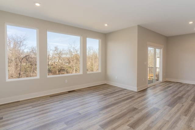 unfurnished room with light hardwood / wood-style flooring