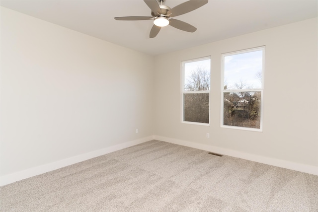 spare room featuring ceiling fan and carpet flooring