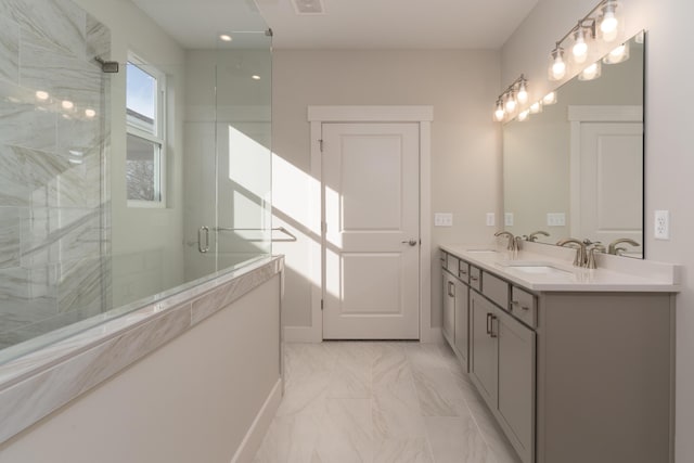 bathroom featuring vanity and a shower with shower door