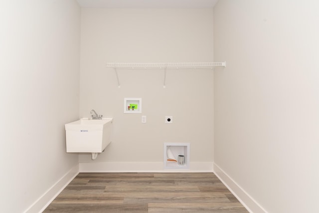 washroom featuring hardwood / wood-style floors, hookup for a washing machine, sink, and hookup for an electric dryer