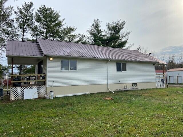 view of side of home with a yard